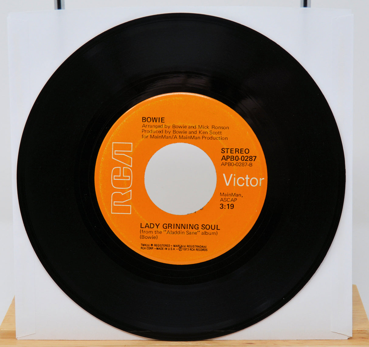 Vinyl record with orange label on a white background
