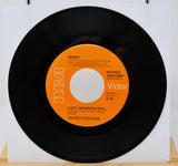 Vinyl record with orange label on a white background