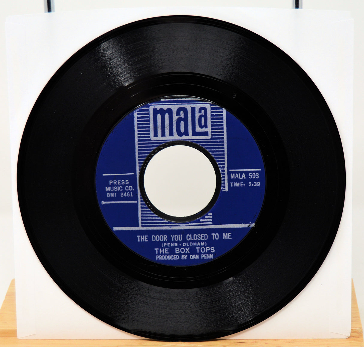 Black vinyl record with blue label on a white background