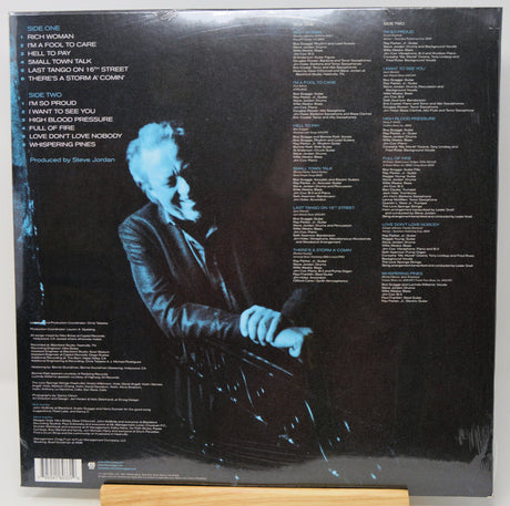 The back cover of a vinyl record sleeve for Steve Jordan's album 'Side Two', displayed on a wooden stand against a white background.
