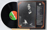 Vinyl record with a smiling person on the cover and a visible label.