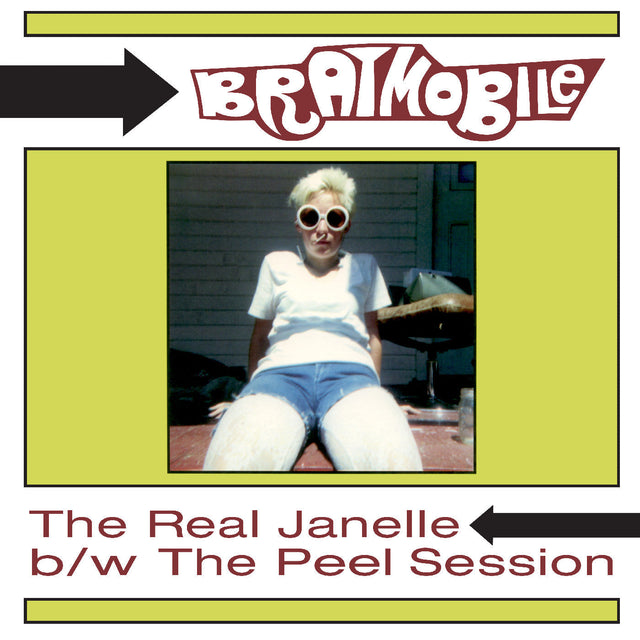 Front cover of Bratmobile The Real Janelle b/w The Peel Session album featuring a woman sitting outdoors