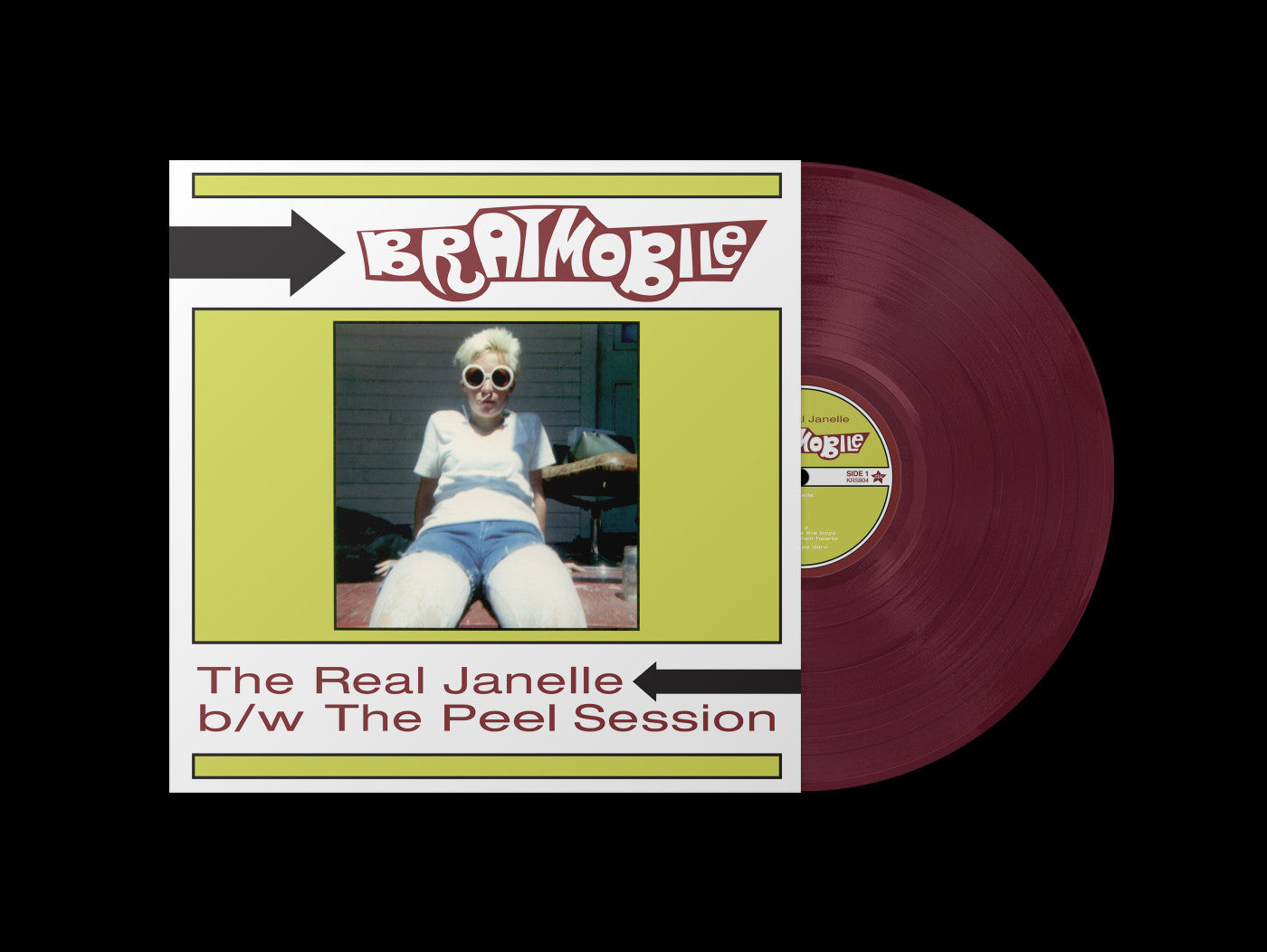 Bratmobile The Real Janelle vinyl record with cover artwork featuring a woman in sunglasses