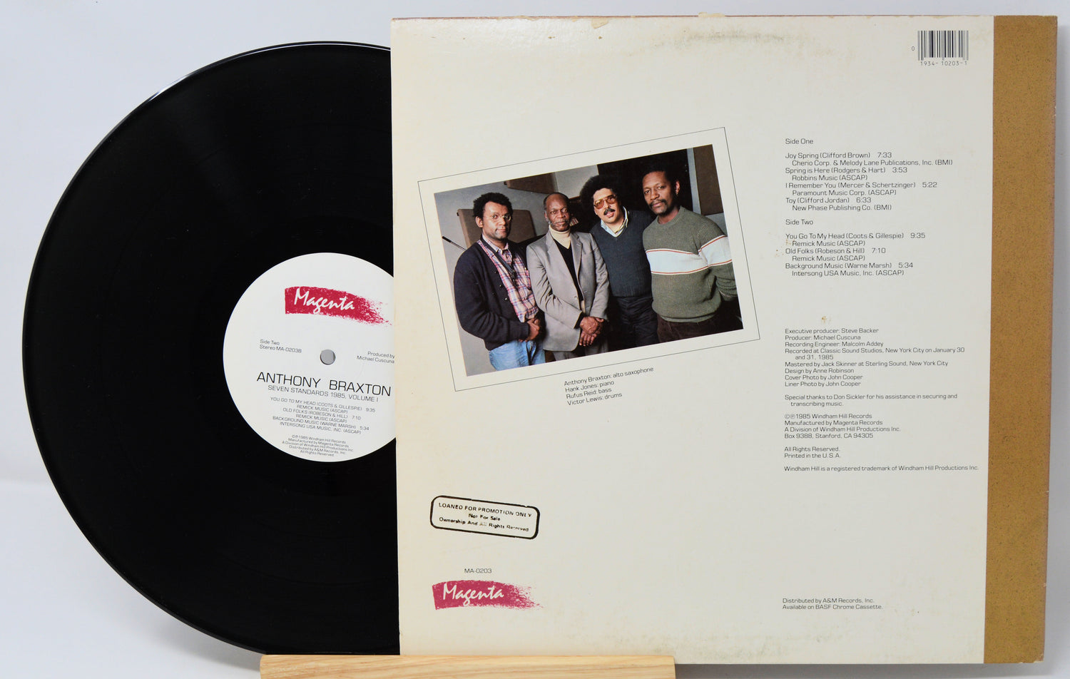 Vinyl record with cover featuring a group of people and album details.