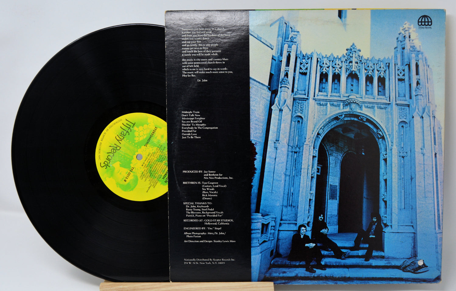 Vinyl record by Brethren with a black cover featuring a yellow label and a blue album cover with architectural design.