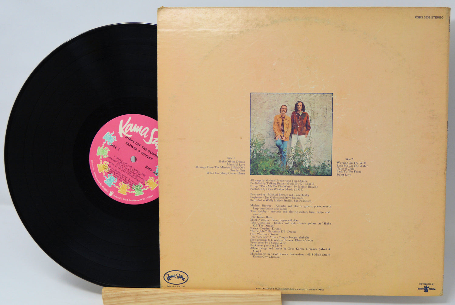 Vinyl record with pink label and cover featuring two people outdoors.