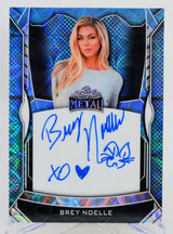 Autographed card of a person wearing a shirt with 'Metal' branding, set against a blue and black decorative border.