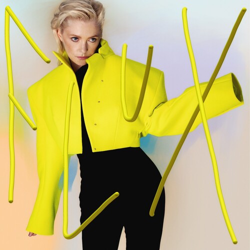 Model wearing a bright yellow cropped statement jacket with abstract yellow lines and a gradient background