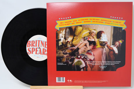 Britney Spears Circus vinyl record with back cover featuring track list and whimsical circus-themed room scene