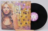 Front cover of Britney Spears' Oops!... I Did It Again 25th Anniversary vinyl with vinyl record partially visible