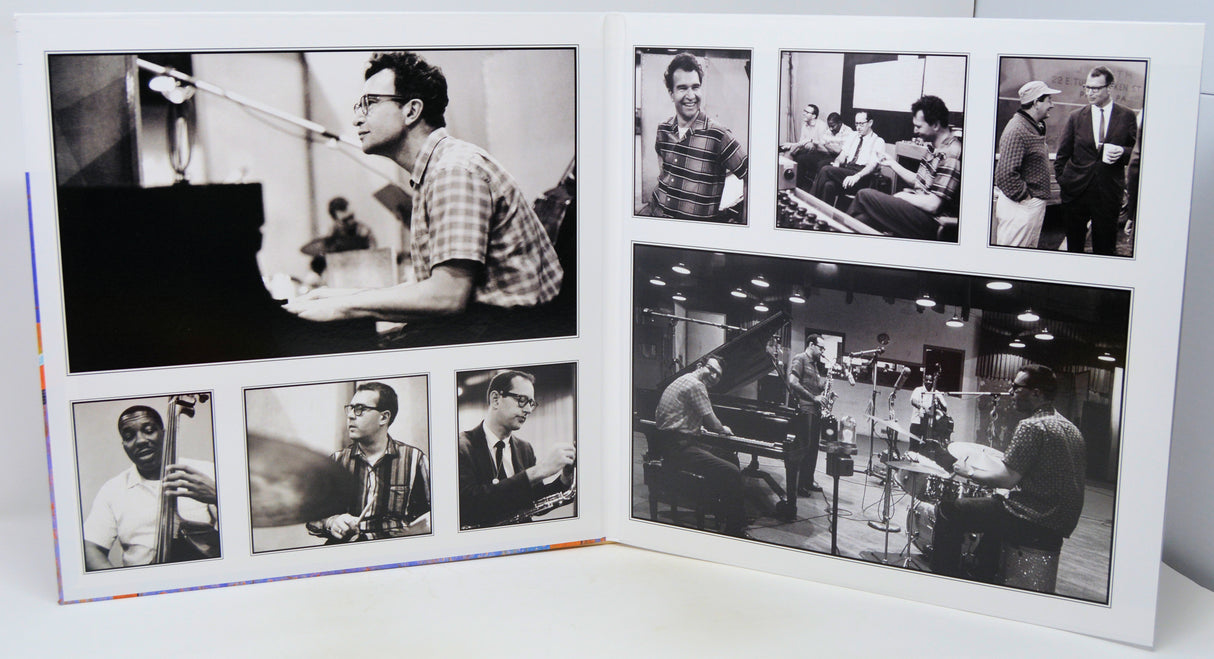 A square white collage print featuring multiple black-and-white photographs of jazz musicians, including Louis Armstrong, Duke Ellington, and others, displayed on a white surface.