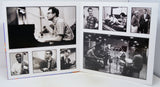 A square white collage print featuring multiple black-and-white photographs of jazz musicians, including Louis Armstrong, Duke Ellington, and others, displayed on a white surface.