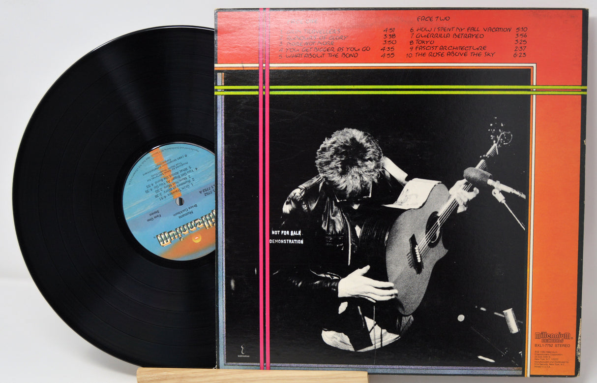 Vinyl record with cover featuring a guitarist on a white background