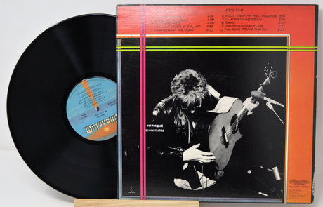 Vinyl record with cover featuring a guitarist on a white background