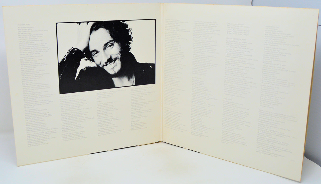 Open book with a black and white photo of a person on the left page.