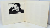 Open book with a black and white photo of a person on the left page.