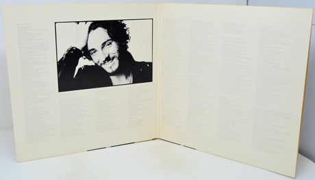 Open book with a black and white photo of a person on the left page.