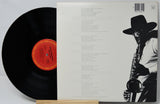 Vinyl record with a black and white cover featuring a saxophonist.