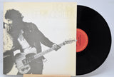 'Bruce Springsteen Born To Run' Vinyl record with a cover featuring a black and white image of Bruce playing guitar
