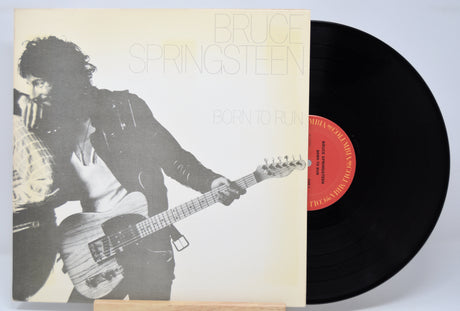 'Bruce Springsteen Born To Run' Vinyl record with a cover featuring a black and white image of Bruce playing guitar