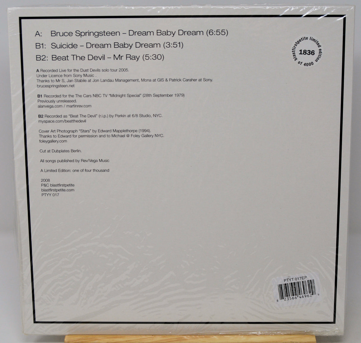 The back cover of a vinyl record sleeve for Bruce Springsteen's 'Dream Baby Dream', showing track listing, credits, and barcode on a white background.