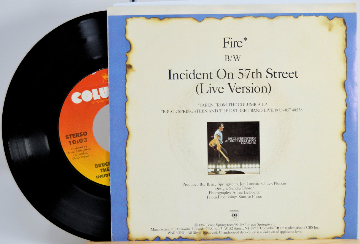 Back cover and record of Bruce Springsteen's 'Fire' 45 RPM vinyl single featuring track details