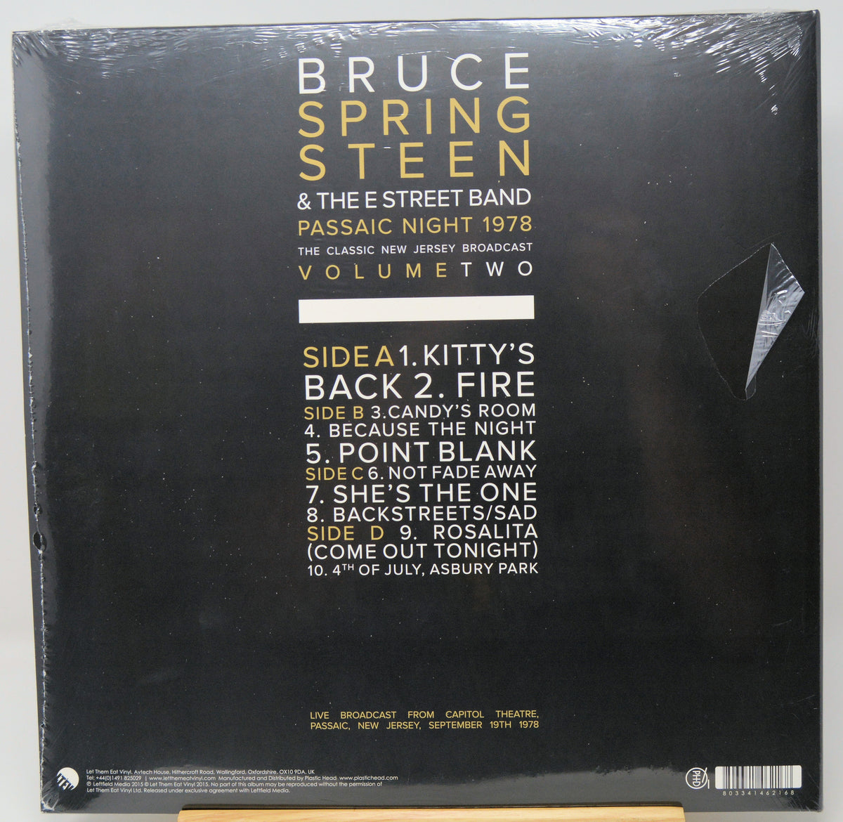 The back cover of a Bruce Springsteen & The E Street Band vinyl record, titled 'Passaic Night 1978: Volume Two'. The cover is black with gold and white text listing the tracklist, and the album is shown sealed in its original plastic shrink wrap.