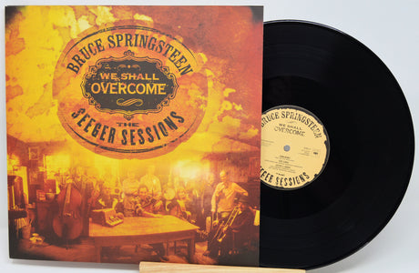 Bruce Springsteen's 'We Shall Overcome' 'Jester Sessions' vinyl record album, showing the illustrated front cover and the black vinyl record partially pulled out, on a white background.