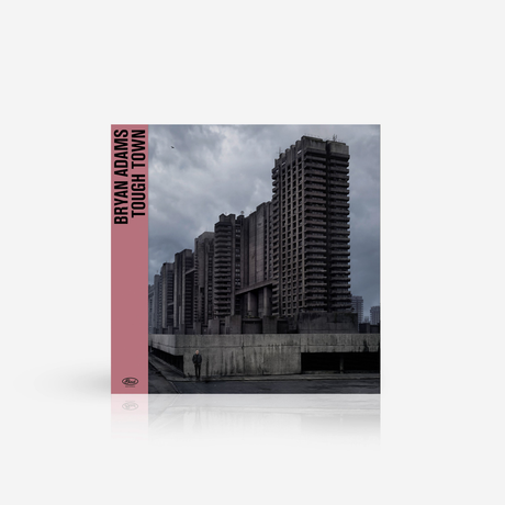 Vinyl record cover of 'Tough Town' by Bryan Adams with a cityscape background