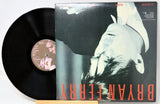 Vinyl record with cover featuring a black and white image of a person and red text.