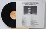 Buddy Holly vinyl record titled '20 Golden Greats' and the back cover with a photo of him and text for the song titles and credits.
