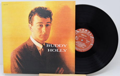 Buddy Holly vinyl record album with the LP partially pulled from the jacket sleeve, showing the black record and the cover art on a light gray background.