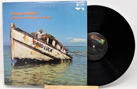 Vinyl record with a cover featuring a boat and the title 'Good Luck' on a blue background.