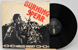 Vinyl record with 'Burning Spear' album cover featuring a figure holding a spear.