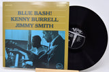 Vinyl record with cover featuring 'Blue Bash!' by Kenny Burrell and Jimmy Smith on a white background.
