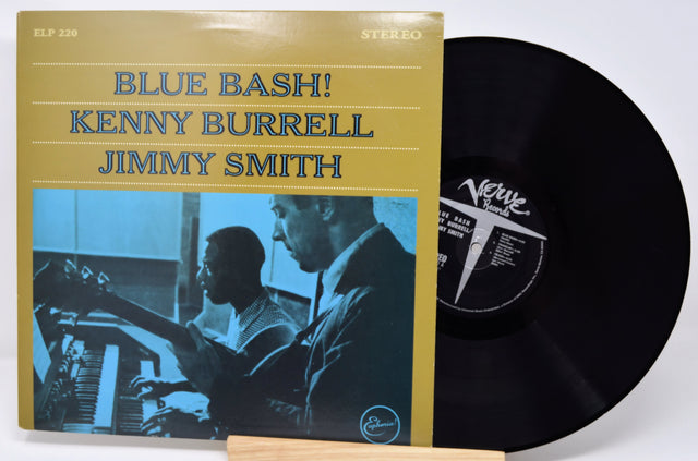 Vinyl record with cover featuring 'Blue Bash!' by Kenny Burrell and Jimmy Smith on a white background.