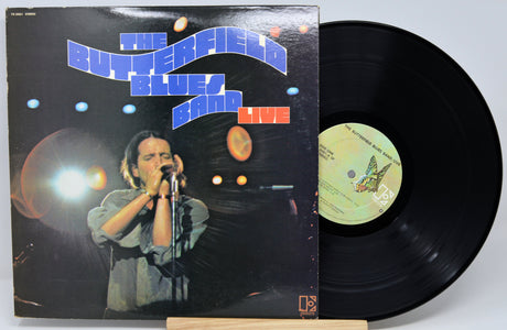 The Butterfield Blues Band 'Live' vinyl record album with the black LP partially pulled from the jacket, displayed on a small wooden stand against a light gray background.