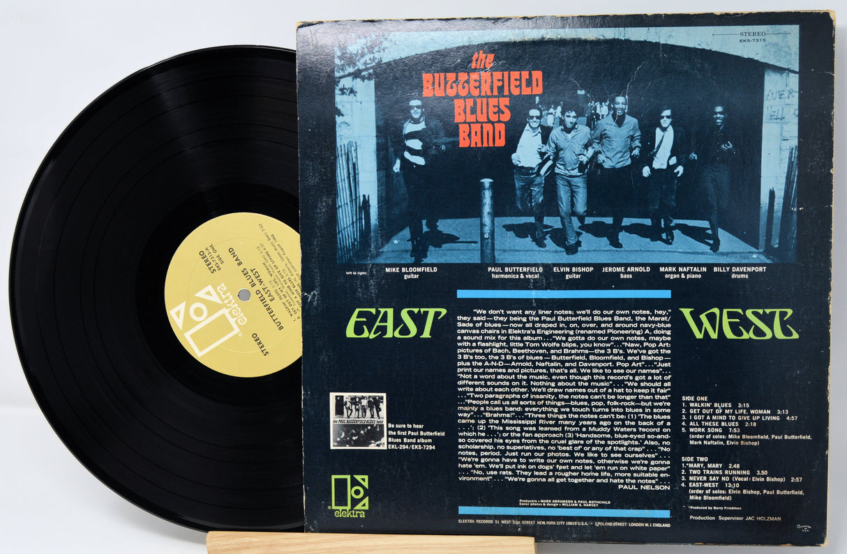 Vinyl record with cover featuring a band and text on a white background