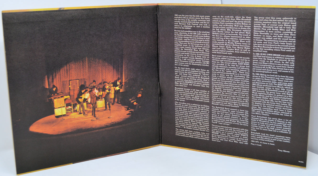 Open book with a stage performance illustration on one page and text on the other.