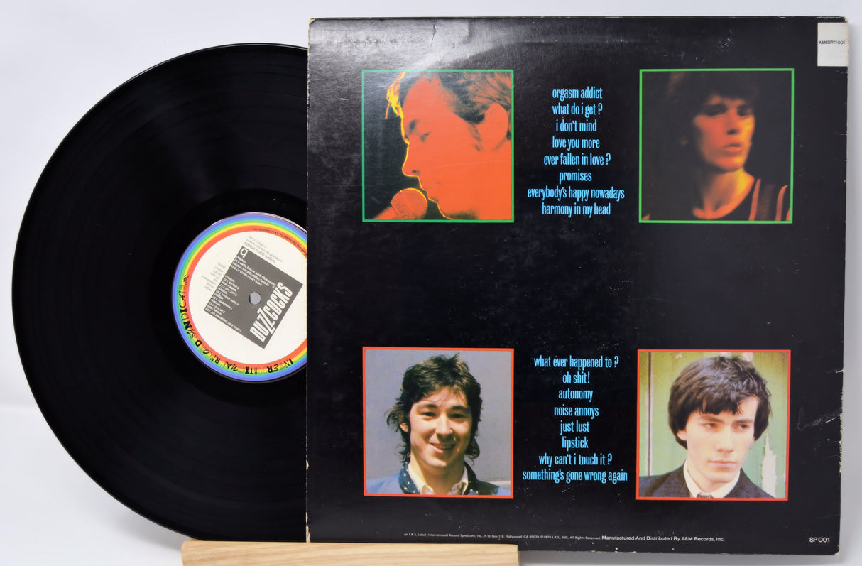 Vinyl record with a colorful cover featuring four portraits and text.