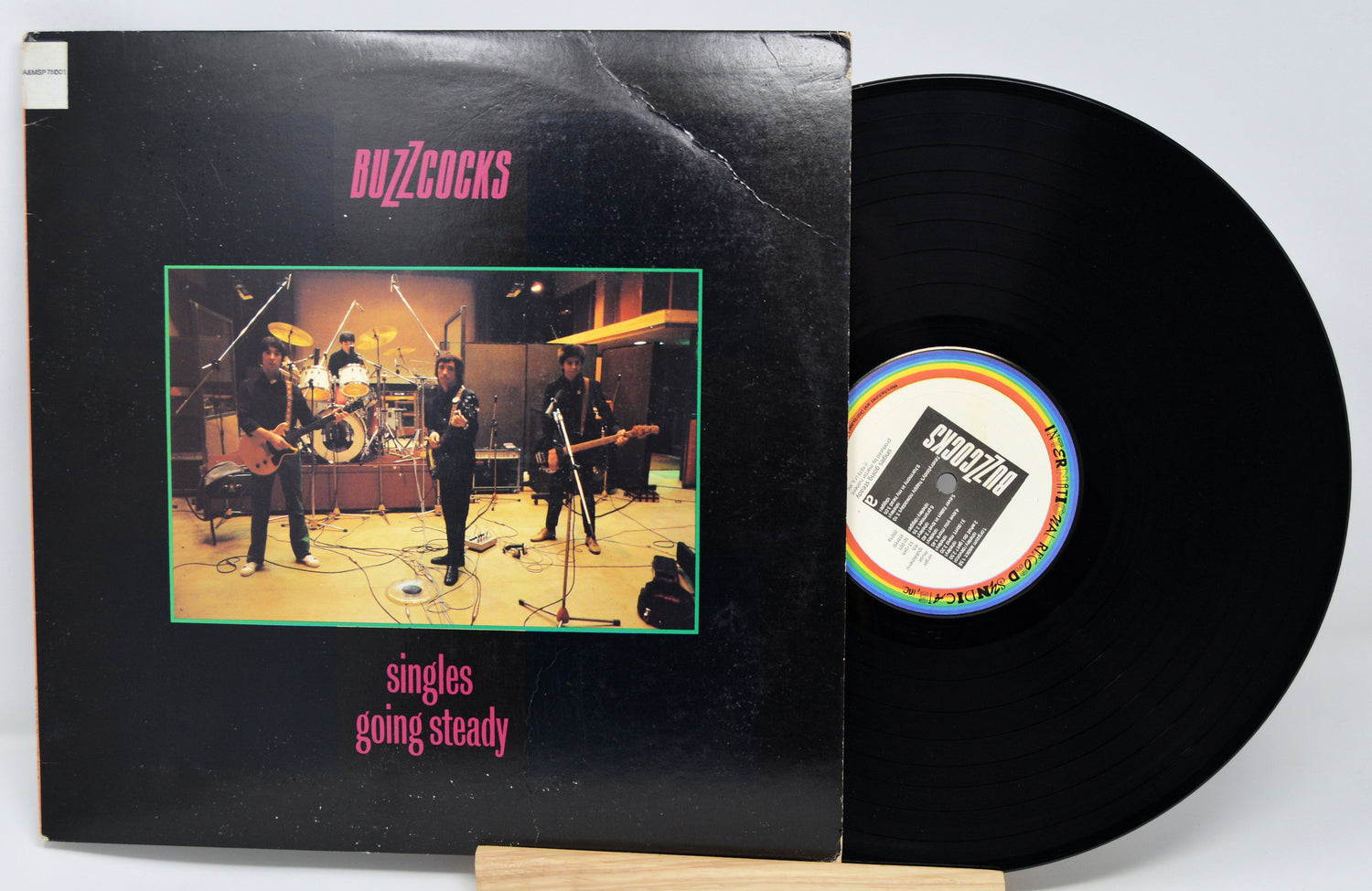 Vinyl record with 'Buzzcocks' album cover showing band on stage.
