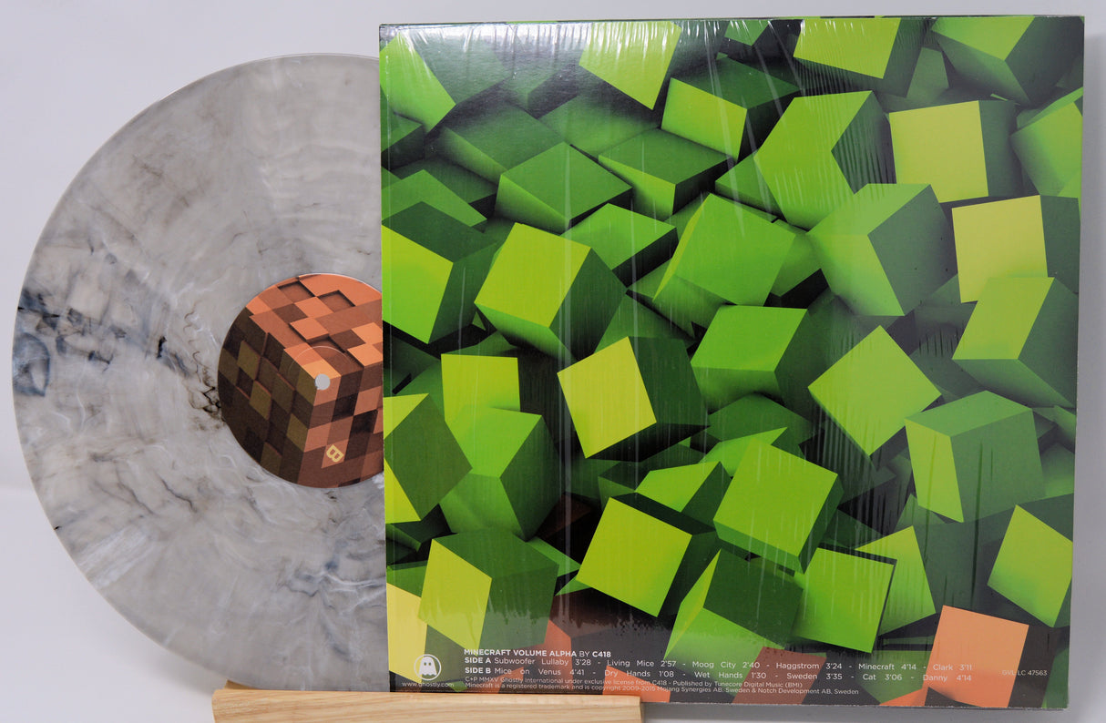 Vinyl record with a geometric green cover design on a white background