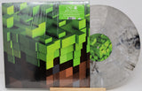 Vinyl record with pixelated green design on a white background