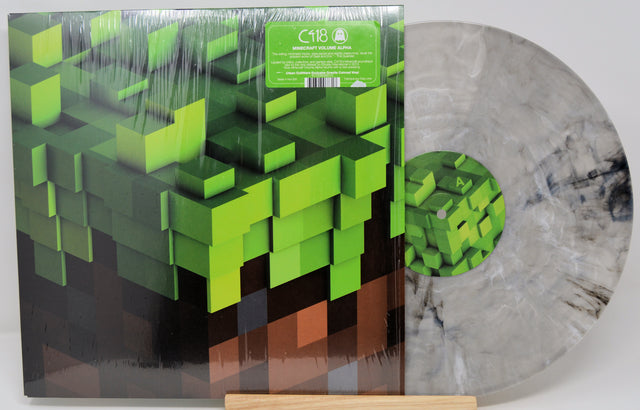 Vinyl record with pixelated green design on a white background