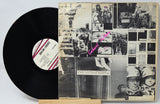 Vinyl record with a collage-style cover featuring black and white images and text.