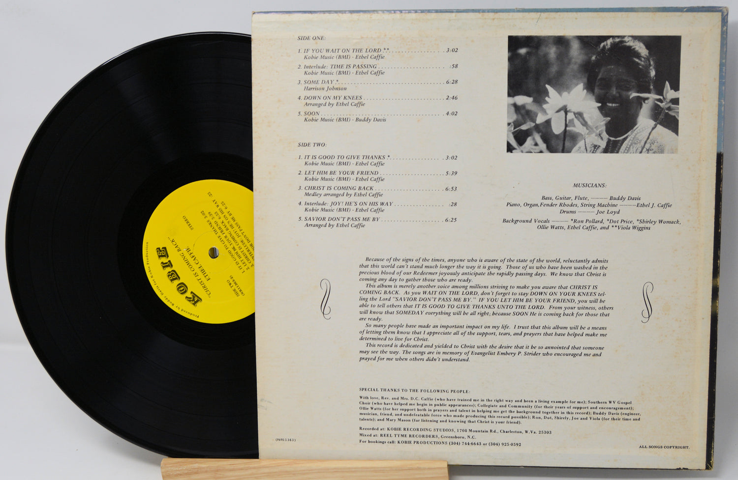 Vinyl record with yellow label and cover featuring text and a photo of a person.