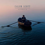 Calum Scott sitting in a wooden rowboat on calm water at sunset for the Avenoir album cover