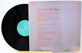 Vinyl record album shown with the black record partially pulled from the sleeve, featuring the title 'The Carla Bley Band' and a teal center label on a white background.