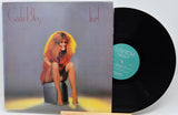 Carla Bley 'live!' vinyl record LP with the printed cover partially pulled from the black record, photographed against a plain light background.