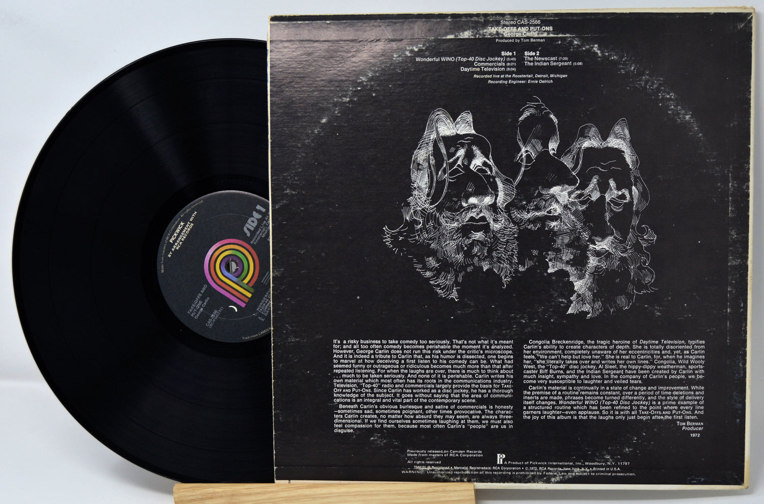Vinyl record with cover featuring abstract design and text on a light gray background